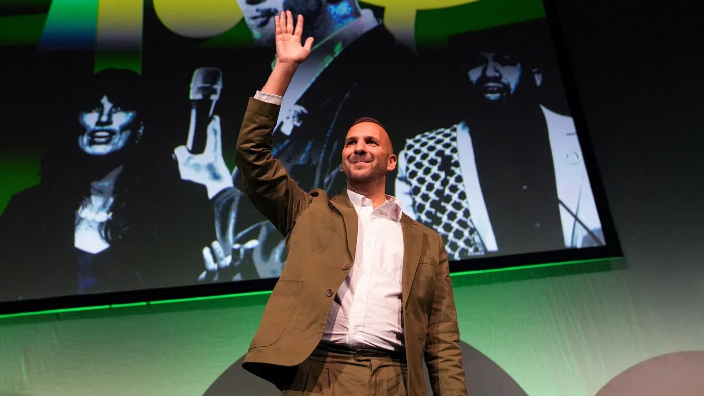 Green leader Zack Polanski waves to attendees at the party's conference in Brighton on 2 October 2026 (Carlos Jasso/Reuters)