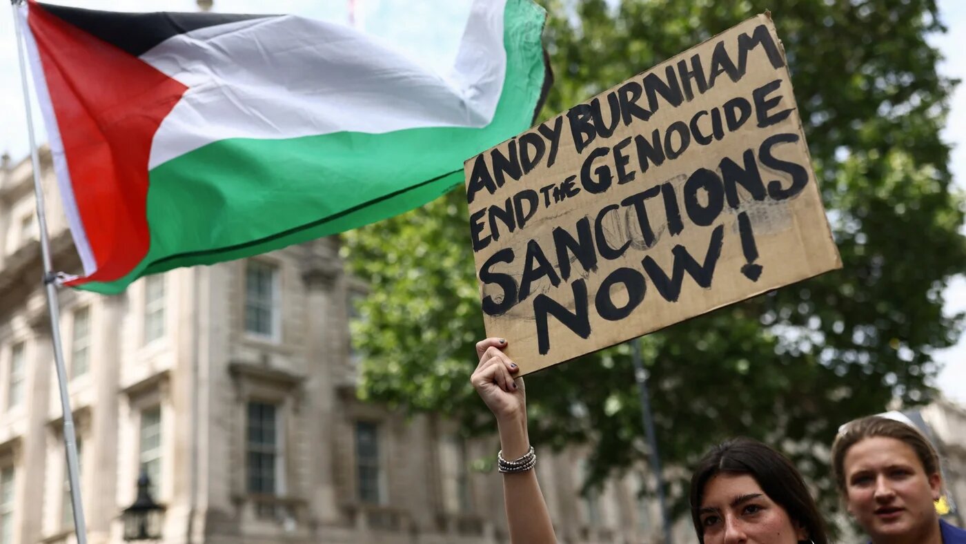 A woman holds a placard outside Downing Street during a "National March for Palestine" in London, Britain, 18 July 2026 (Jack Taylor/Reuters)