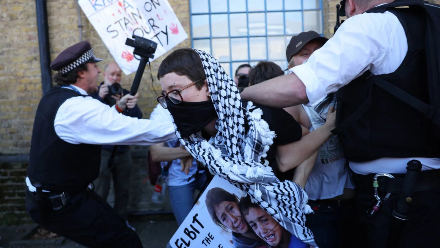 Demonstrators protest outside the entrance to the Defence and Security Equipment International (DSEI) fair at the ExCeL centre, London, on 9 September 2025 (AFP)