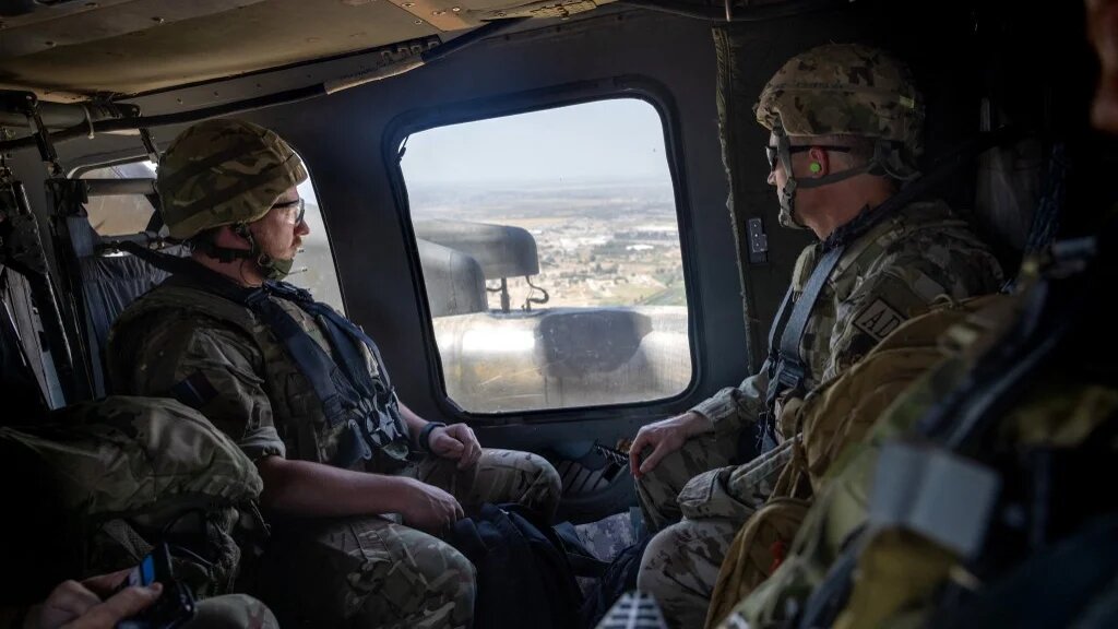 Coalition soldiers fly to Baghdad in a US Blackhawk helicopter on 31 May 2021.