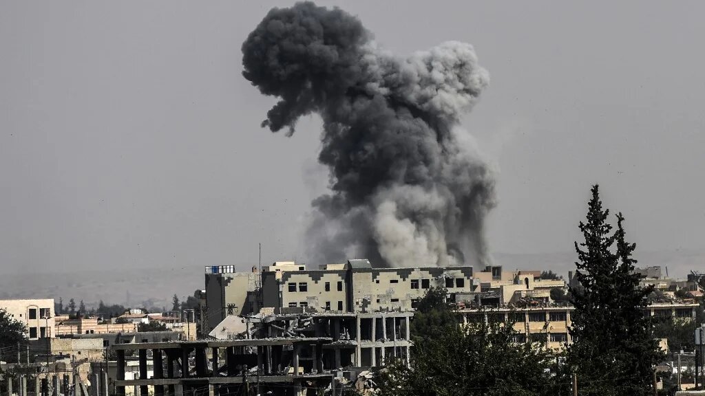 Smoke billows following an air strike on the western frontline of Raqqa on 17 July 2017.