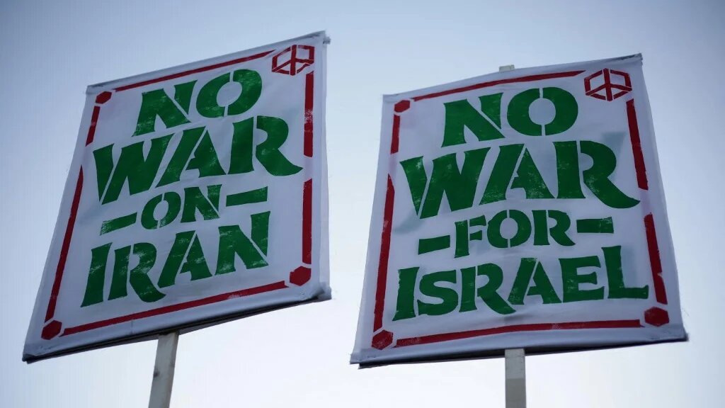 Antiwar demonstrators hold signs as they gather near the White House in Washington, DC, on 7 April 2026 (Alex Wong/Getty Images/AFP)