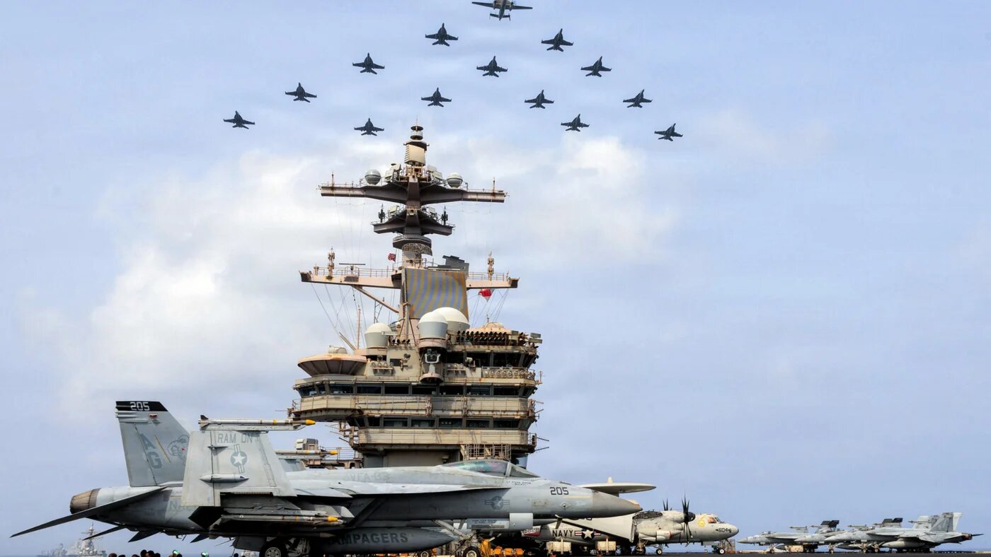 This US Navy handout photo taken on 30 June 2026 by US Central Command Public Affairs shows the Carrier Air Wing 7 flying in formation over the USS George H.W. Bush in the Arabian Sea (AFP)