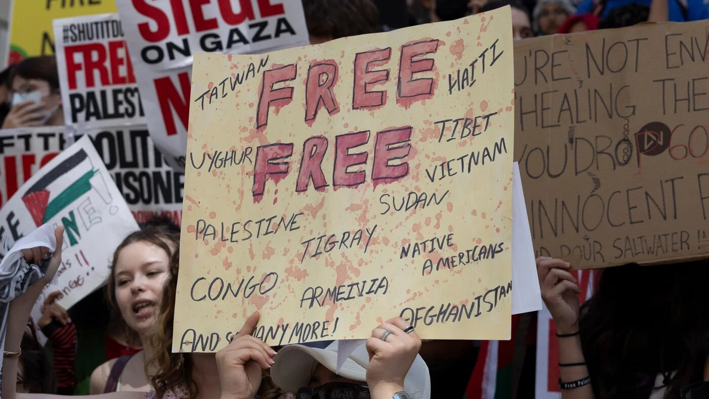 Protesters at a rally for Gaza hold signs urging global attention on Palestine and other conflicts in New York City on 31 May 2024 (Gina M Randazzo/Zuma Press Wire via Reuters)