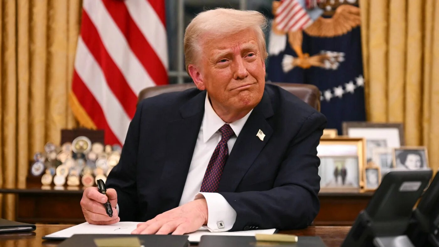 US President Donald Trump signs executive orders in the Oval Office of the White House in Washington, DC, on 20 January 2025 (AFP)