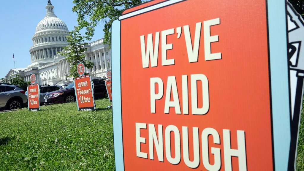 Signs protesting the Iran war and its impacts on gas prices are seen during a protest outside the US Capitol in Washington, DC, on 20 May 2026 (Kevin Dietsch/Getty Images/AFP)