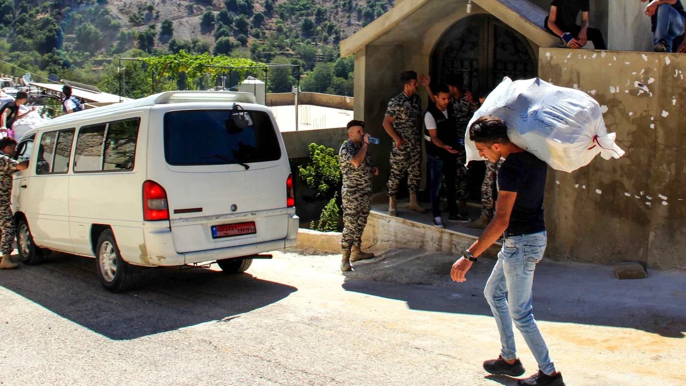 Syrian refugees pack their belongings as they prepare to be evacuated from the southern Lebanese village of Shebaa on 28 July 2018, to return back to Syria.