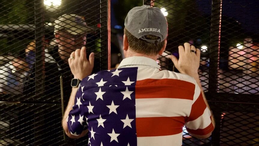 People wait to re-enter the event site after being evacuated due to storms during Independence Day celebrations in Washington, DC, on 4 July 2026 (Amid Farahi/AFP)