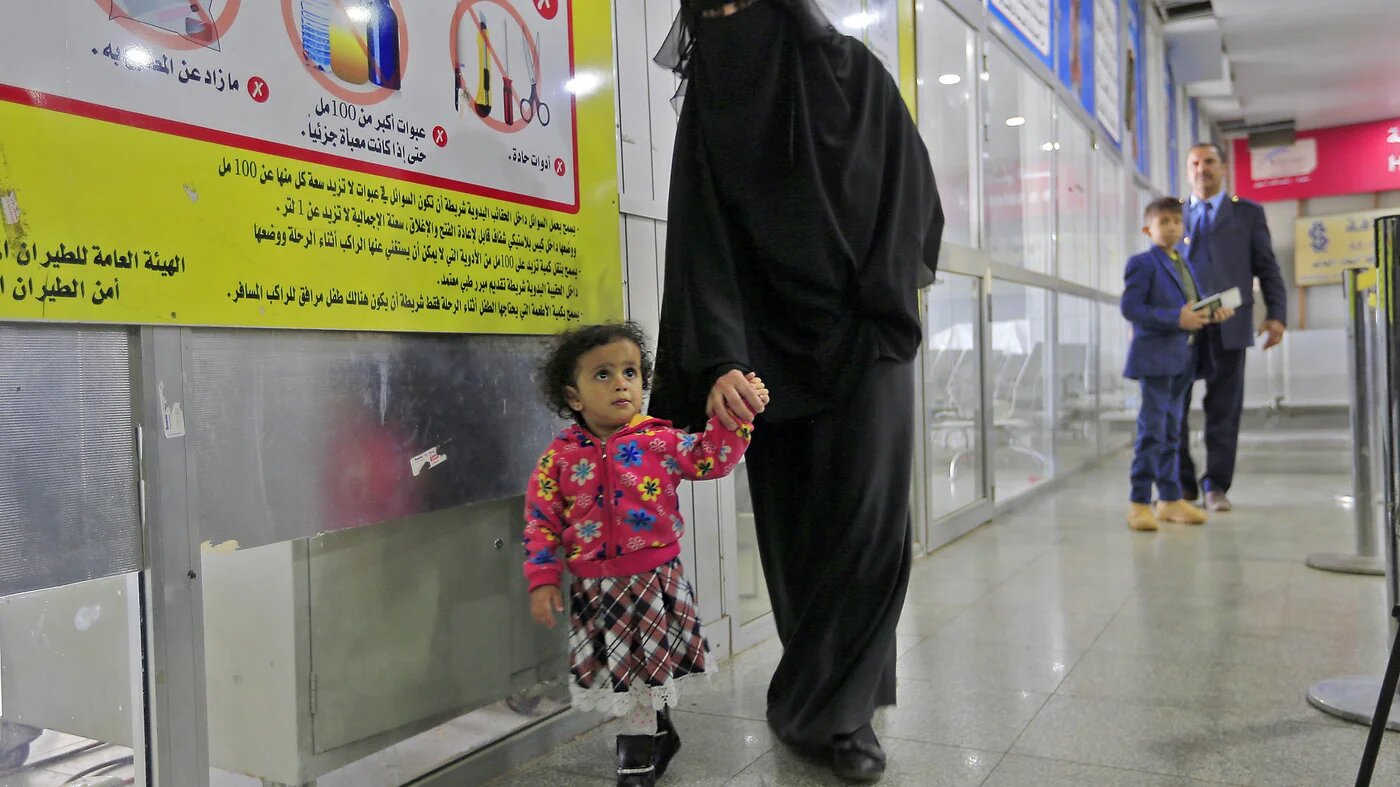 A Yemeni child walks with their guardian at Sanaa International Airport