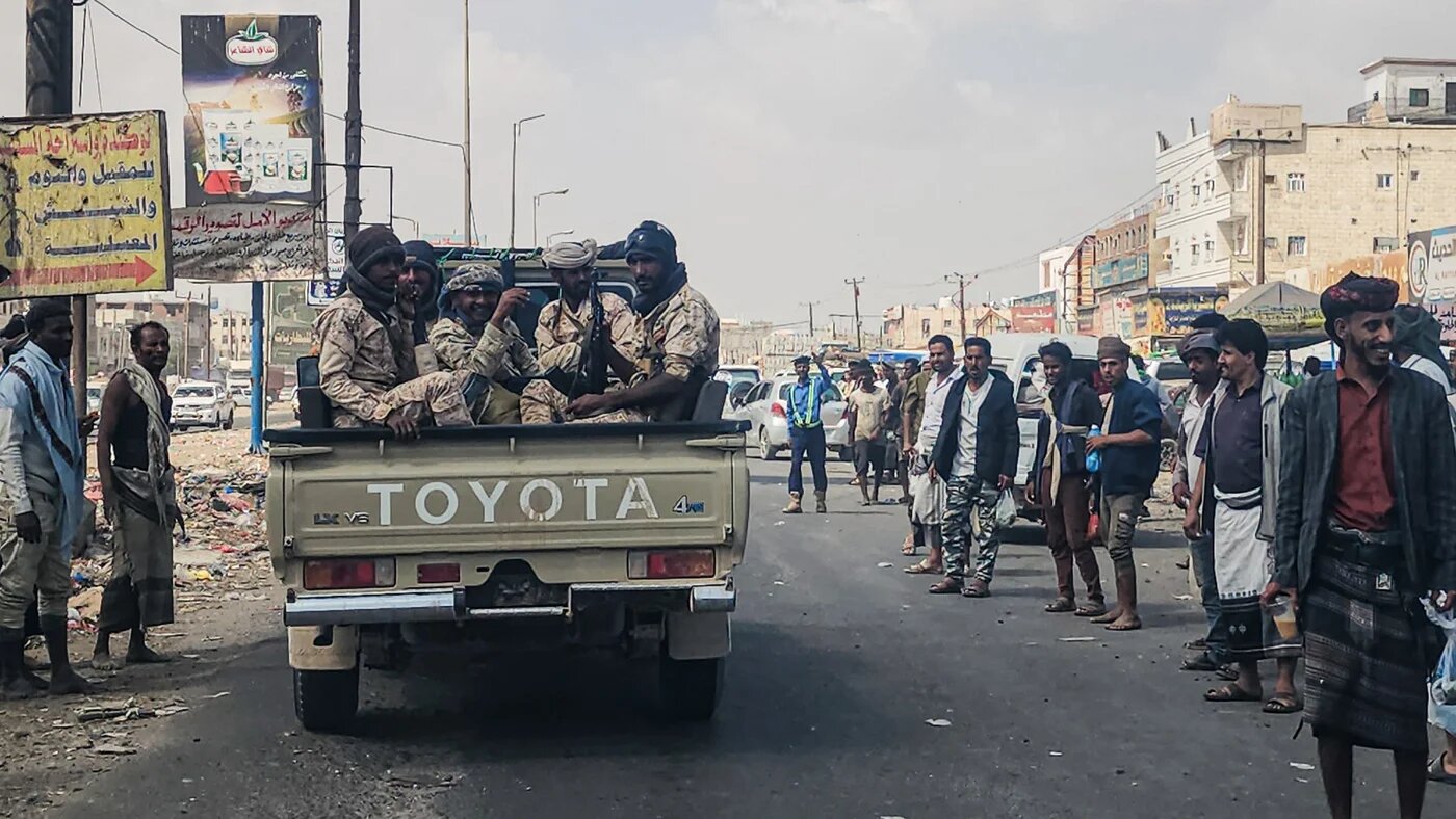 Fighters drive through the streets of the port city of Aden, Yemen, on 8 January 2026 (AFP/Saleh al-Obeidi)