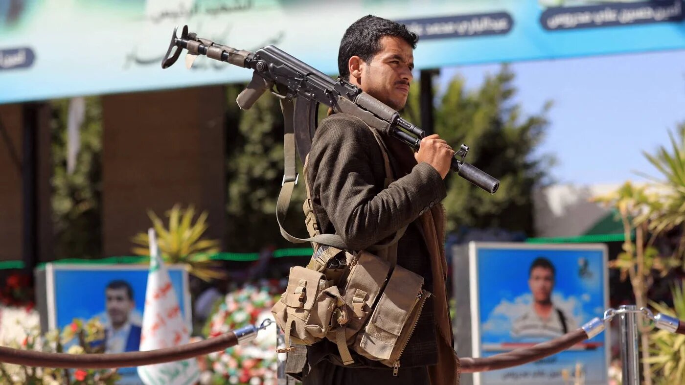 A fighter loyal to Yemen's Houthi rebels visits the grave of slain Houthi political leader Saleh al-Sammad in Yemen's Houthi rebel-held capital Sanaa on 31 January 2022.