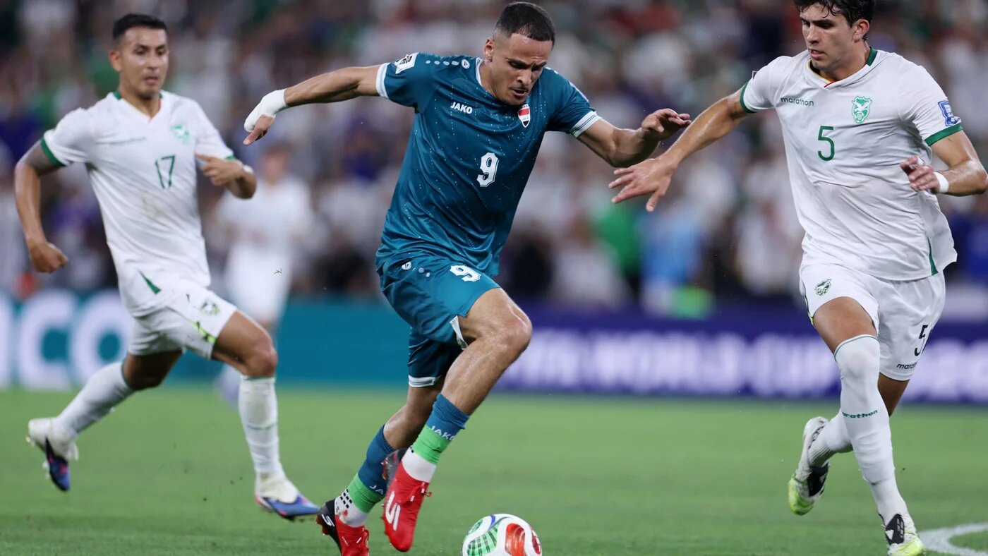 Iraq's Ali al-Hamadi dribbles the ball past Bolivia's defender Efrain Morales during their World Cup qualifier final playoff at the BBVA Stadium in Guadalupe, Nuevo Leon state, Mexico, on 31 March 2026 (AFP/Julio Cesar Aguilar)