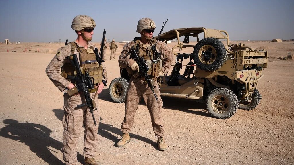 US Marines keep watch as unseen Afghan National Army soldiers participate in a training exercise in the Afghan province of Helmand on 28 August 2017.