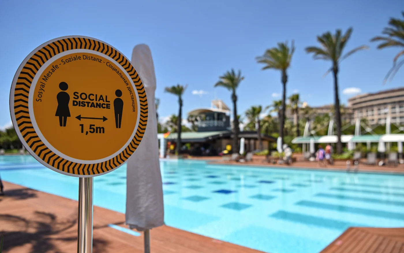 Un panneau indique « distance sociale 1,5m » à côté de la piscine d'un hôtel, à Antalya, le 19 juin 2020 (AFP)