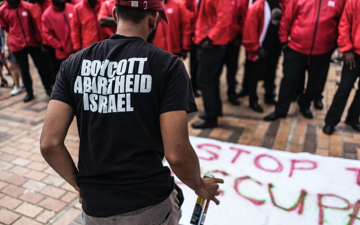 Un militant pro-palestinien peint une banderole contre l’apartheid israélien, à l’Université de Witwatersrand, Johannesburg (Afrique du Sud), le 7 mars 2017 (AFP)