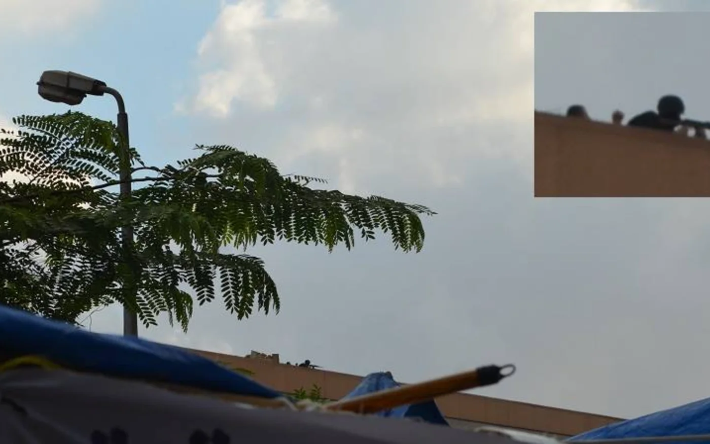 Sniper on roof of the military building on El-Nasr rd