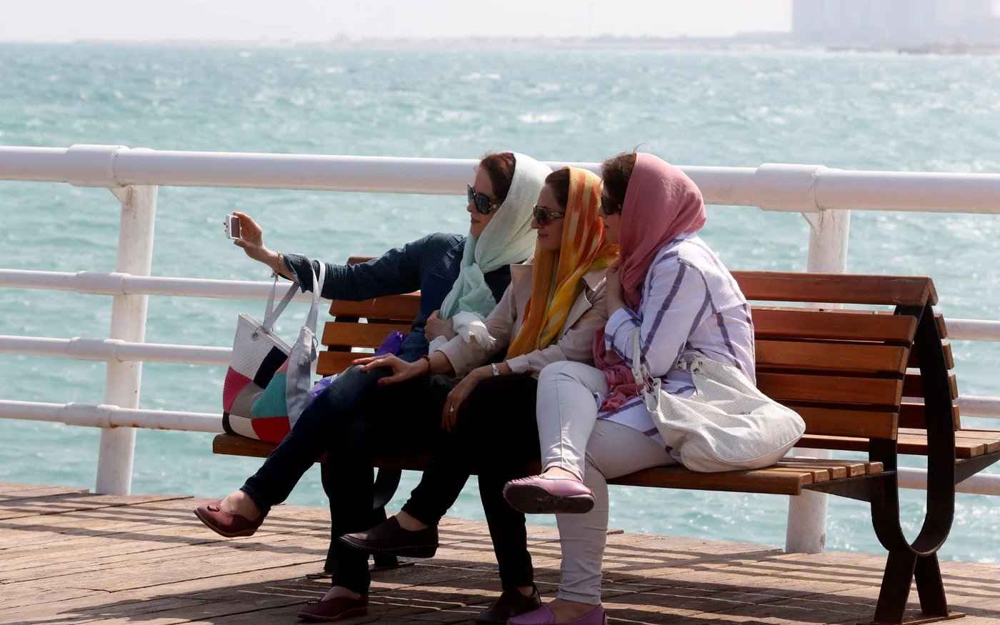 Des Iraniennes prennent un selfie sur le front de mer dans la station balnéaire de Kish, dans le sud de l’Iran, en novembre&nbsp;2016 (Atta Kenare/AFP)