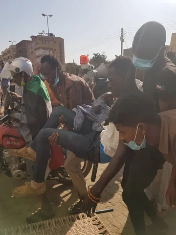 A protester being carried to al-Joda hospital on 6 January (MEE/Mohammed al-Amin)