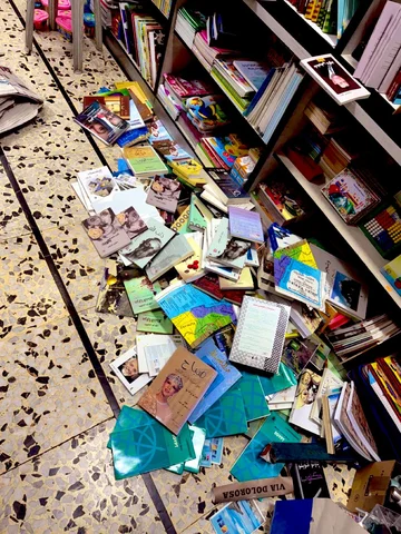 Books thrown on the floor of Jerusalem's Educational Bookshop by Israelis agents (social media)