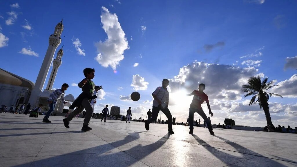 Children play on the esplanade in front of the Hasan Anani mosque in the Saudi Arabian port city of Jeddah on 10 January 2022.
