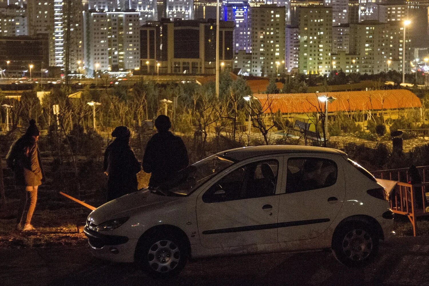 Most of those in this crowd are in their early twenties. One has parked his car close to the fire, rolled the windows down and turned the music up high. A girl asks for a song by Iranian rapper Amir Tataloo, then sings a line out loud: “Life is a treadmill, running without arriving.” (MEE) 