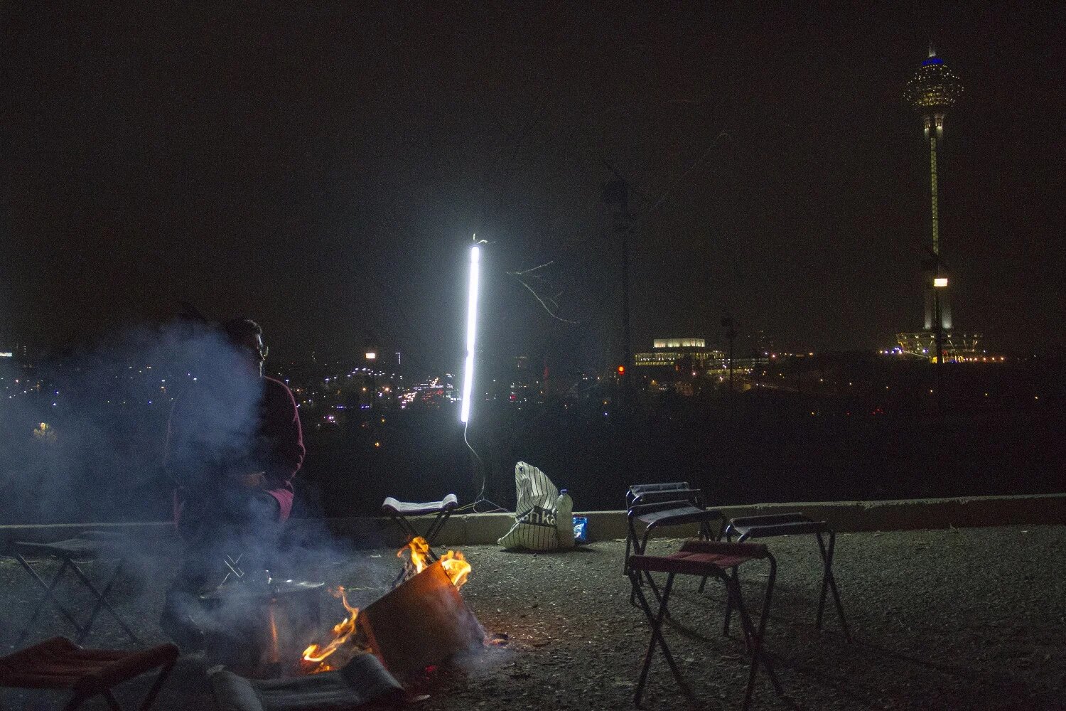 Another popular draw is Pardisan Park in north-west Tehran, close to the upscale Shahrak-e Gharb neighbourhood: here the crowds are mostly from the west and southwest of the city. Some teens just buy a cup of tea or a bowl of homemade soup from sellers, while others use the dark to do what they want, hiding from the morality police and avoiding strict Islamic social regulations. In the background is Milad Tower, a landmark to wealth and capital in Tehran. (MEE) 