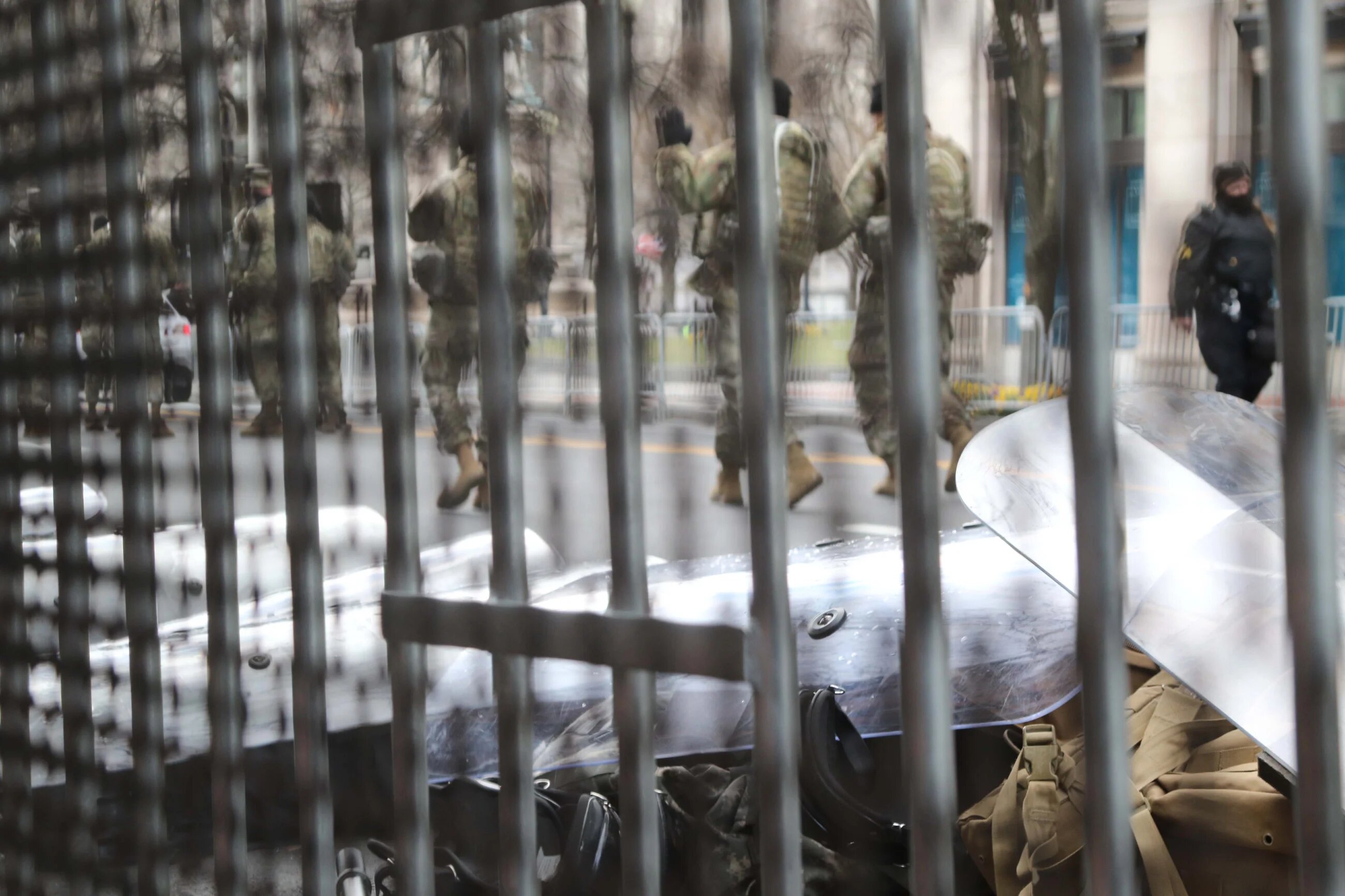 Riot shields and other anti-protest gear lying on the ground near a military checkpoint in downtown Washington.