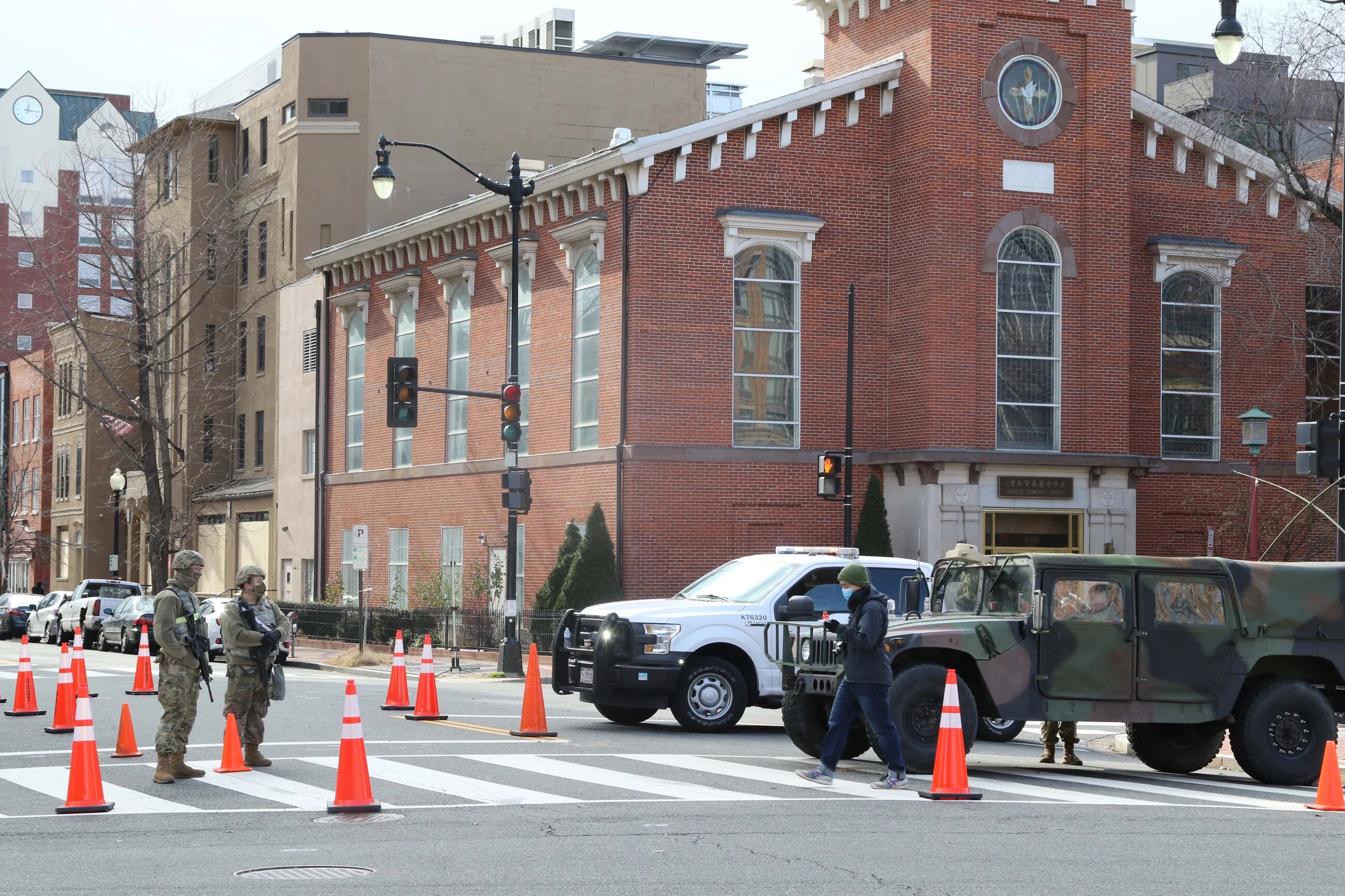 A civilian walks past American troops stationed in Washington on Wednesday morning.