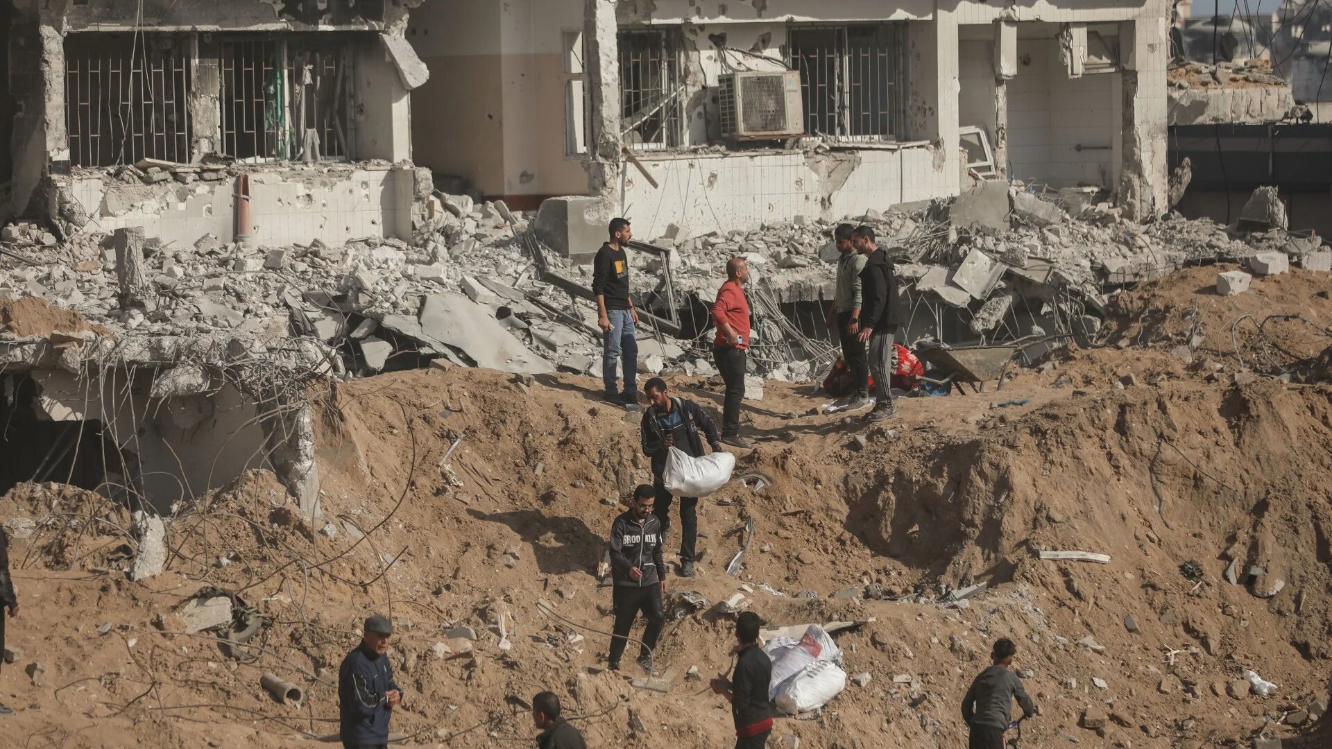 The ground around al-Shifa hospital is heavily plowed up, and numerous buildings outside the facility have either been flattened or burned down by Israeli forces (MEE/Mohammed al-Hajjar)