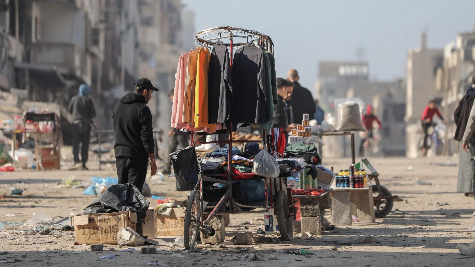 A vendor sells clothes on a street in Gaza City repeatedly targeted by Israeli strikes (MEE/Mohammed al-Hajjar)