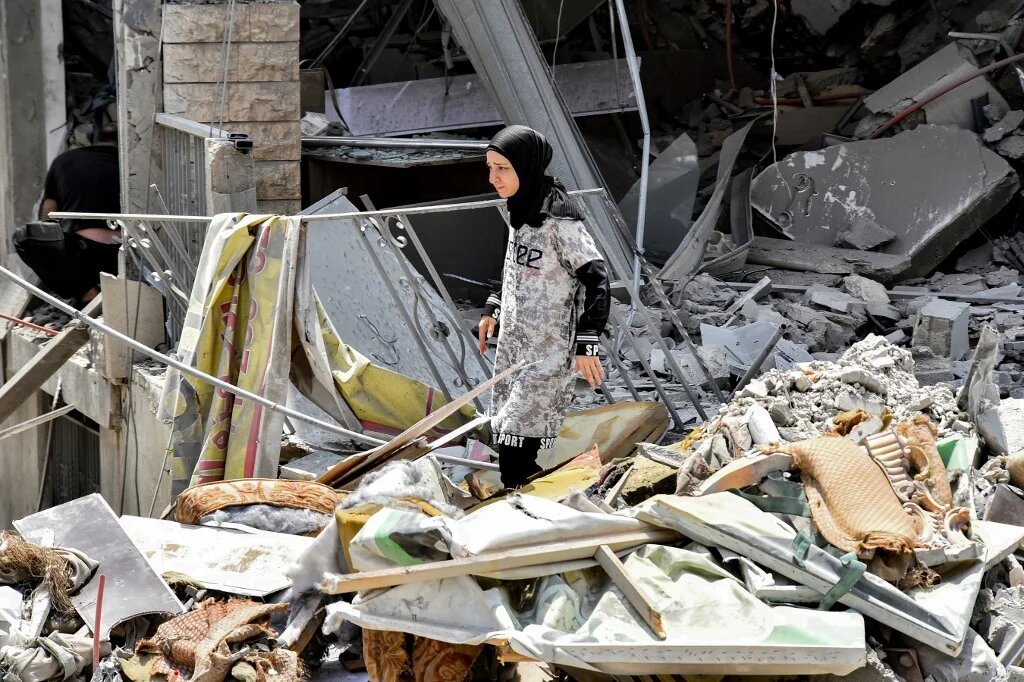 A woman inspects the rubble of a collapsed building in the town of Nabatieh al-Fawqa in southern Lebanon on 23 June 2026 (AFP)