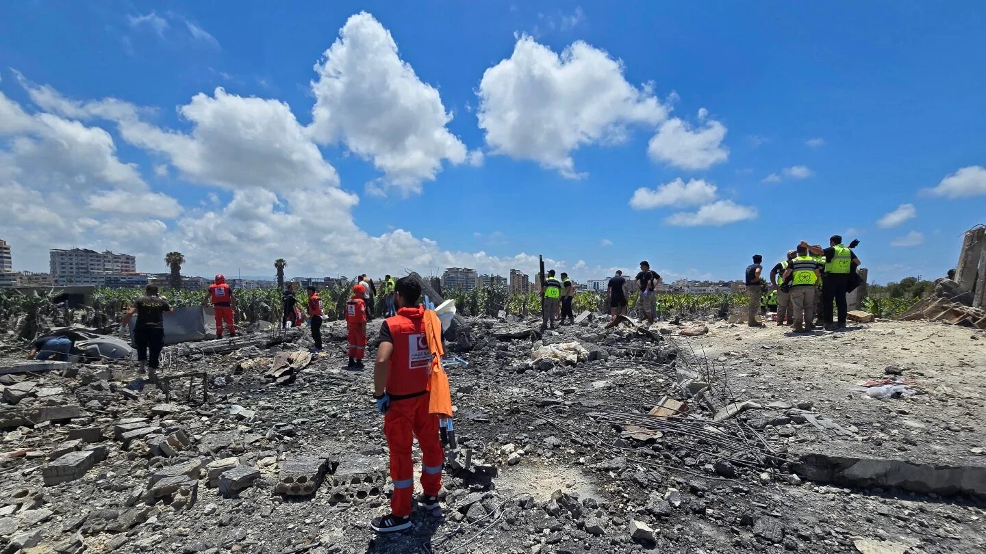 First responders gather at the site of an Israeli strike in the village of Al-Aabbassiyah near the southern Lebanese city of Tyre, 23 May 2026 (Kawnat Haju/AFP)