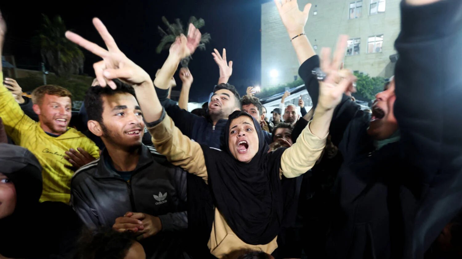 Palestinians react to news on a ceasefire deal with Israel, in Deir Al-Balah in the central Gaza Strip, January 15, 2025. REUTERS