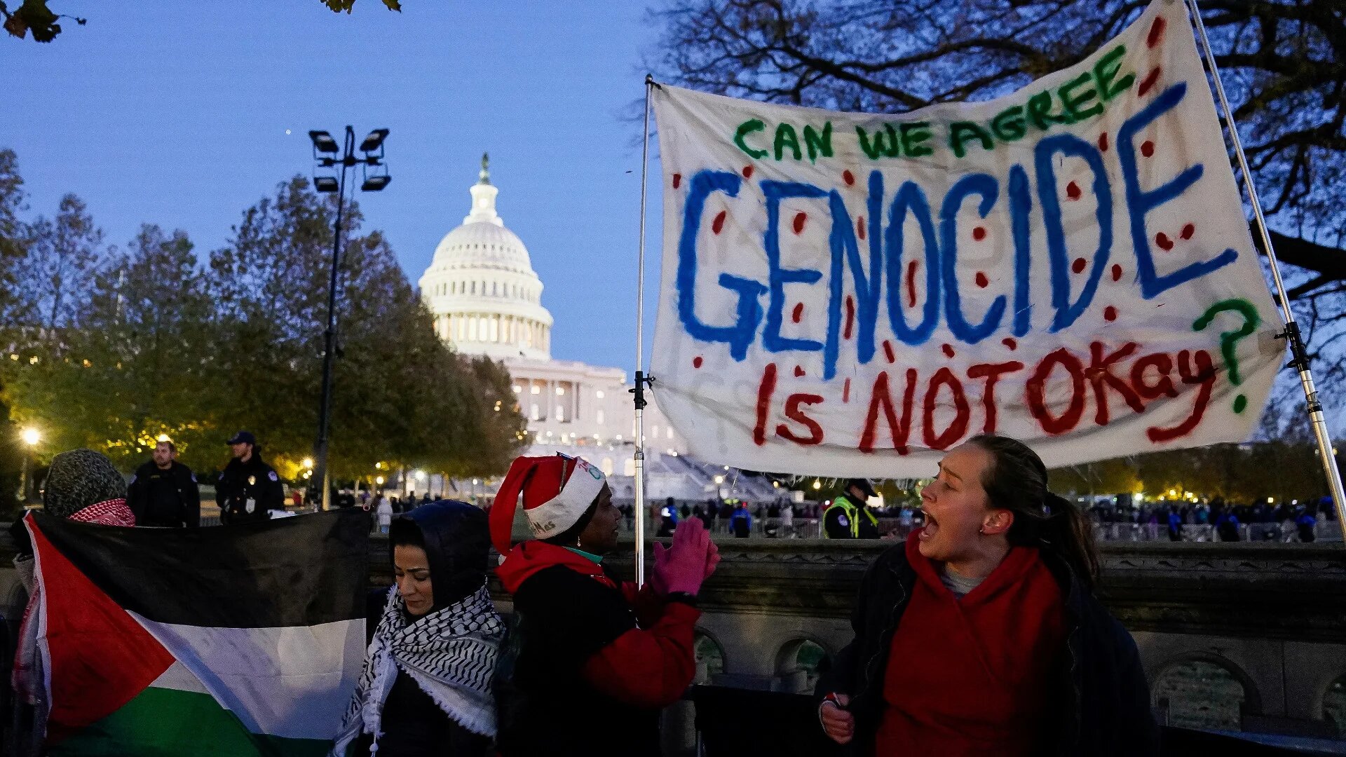 Supporters of Palestinians in Gaza protest outside the annual Christmas tree lighting ceremony at the US Capitol in Washington, DC on 28 November 2023 (Elizabeth Frantz/Reuters)
