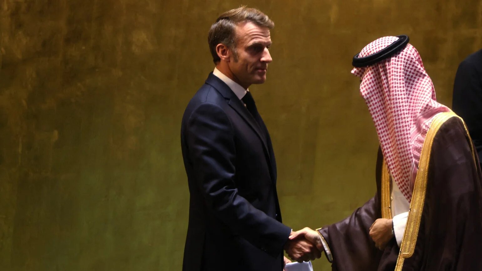 French President Emmanuel Macron shakes hands with Saudi Arabia's Foreign Minister Prince Faisal bin Farhan Al Saud after speaking at a United Nations General Assembly meeting on 22 September 2025 (AFP)
