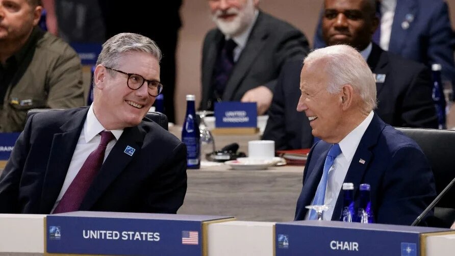 UK Prime Minister Keir Starmer (L) speaks with US President Joe Biden during the Nato 75th anniversary summit in Washington, DC, on 11 July 2024 (Ludovic Marin/AFP)