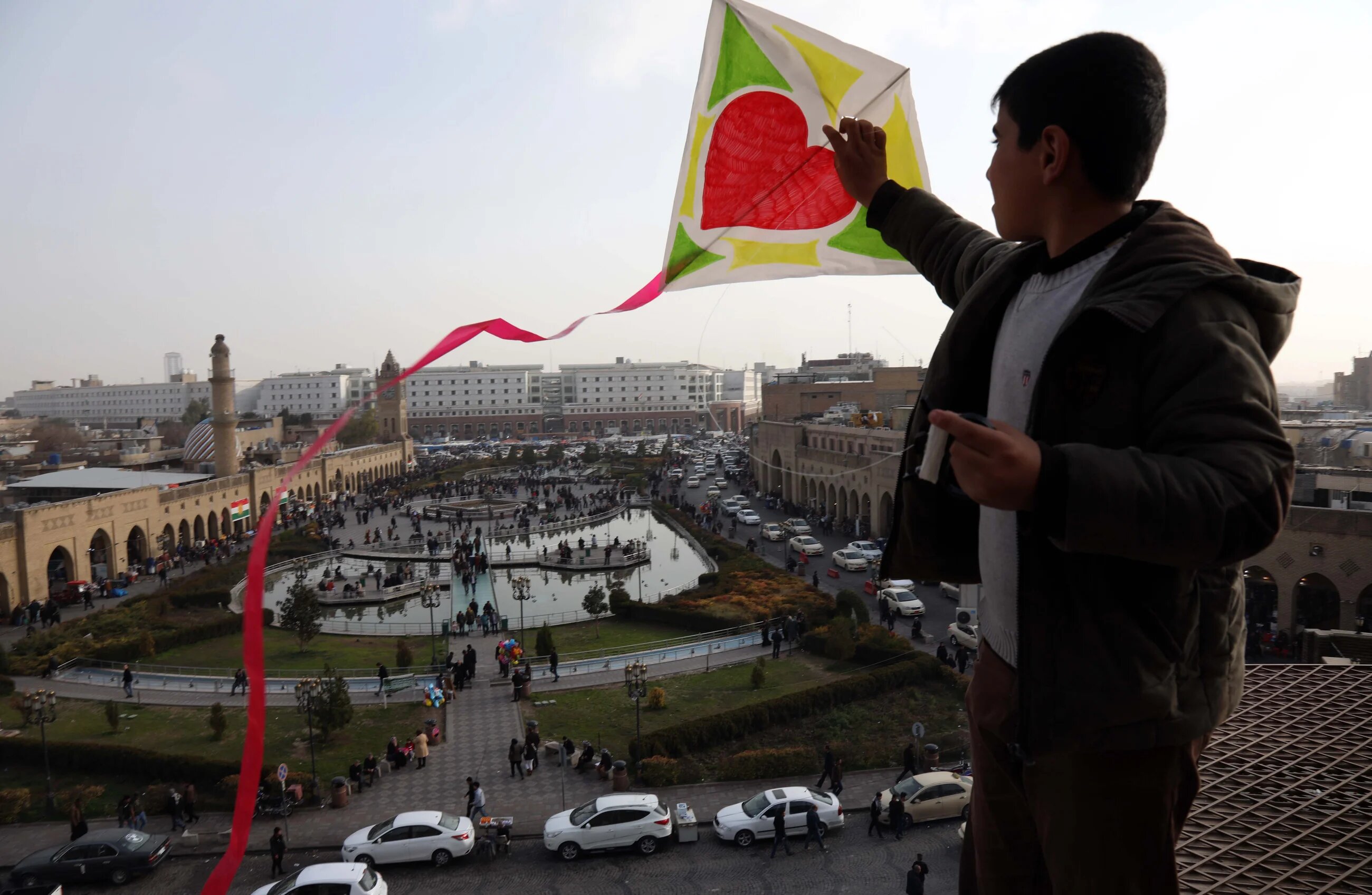 An Iraqi Kurdish child flies a kite in the central square of Erbil