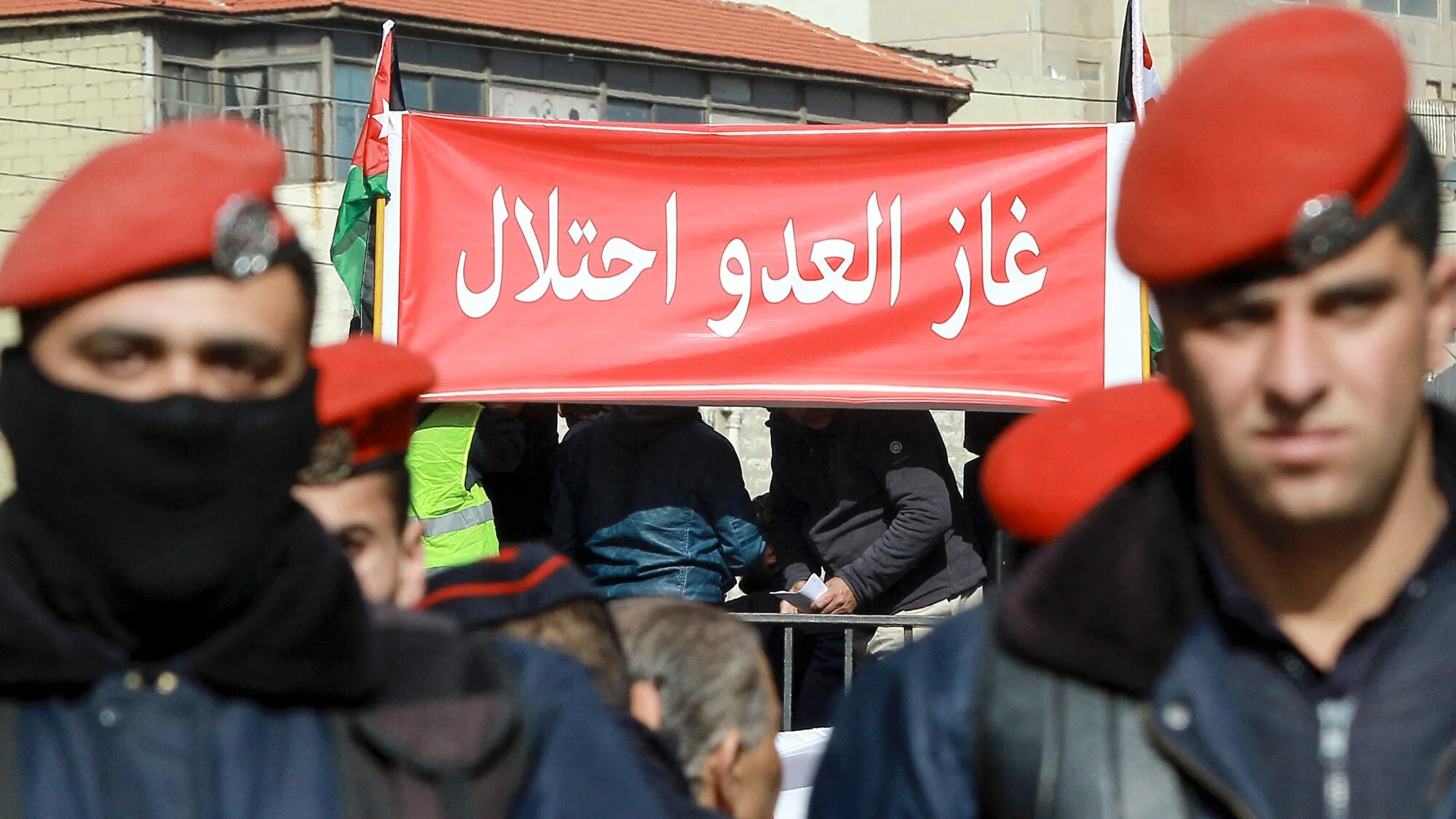 Jordanians hold a sign reading "The enemy's gas is occupation" during a protest in Amman on 3 January 2020 against gas imports from Israel. (AFP/Khalil Mazraawi)