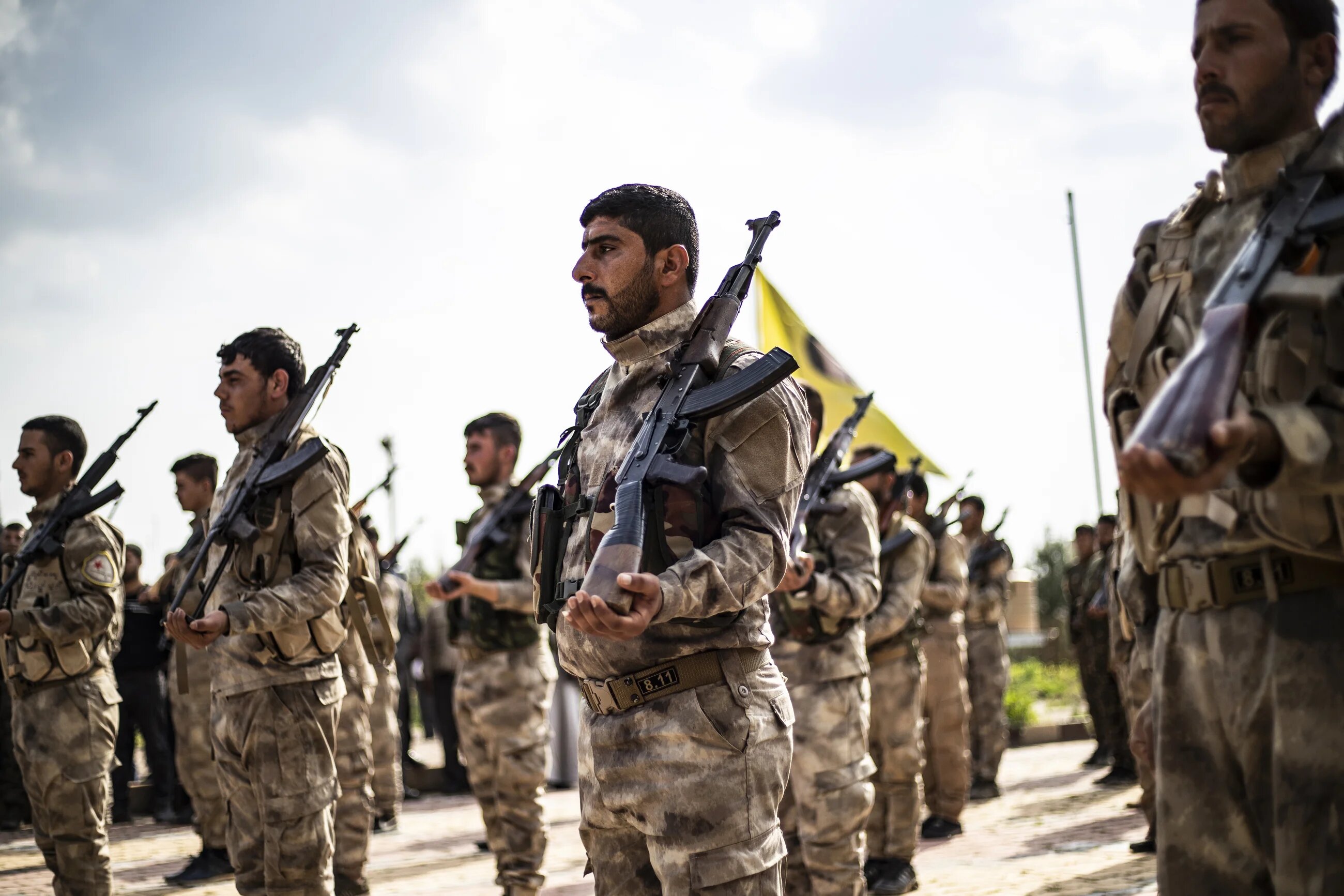 Members of the Kurdish-led Syrian Democratic Forces (SDF) attend the funeral of a fellow fighter in Qamishli, Syria