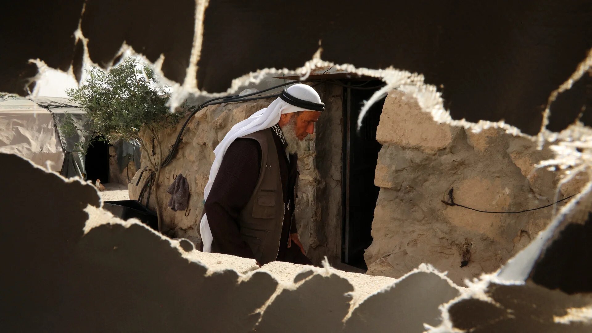 Ali Mohammed Jabbareen, 60, walks at the Palestinian village of Jinba, part of the Masafer Yatta area in the Israeli-occupied West Bank, on 9 May, 2022. (AFP)