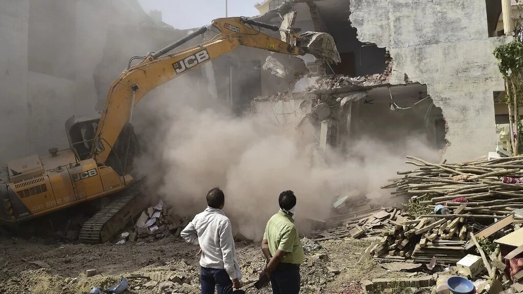 In this file photo taken on June 12, 2022, a JCB bulldozer demolishes a Muslim's house in Allahabad, India (AFP)