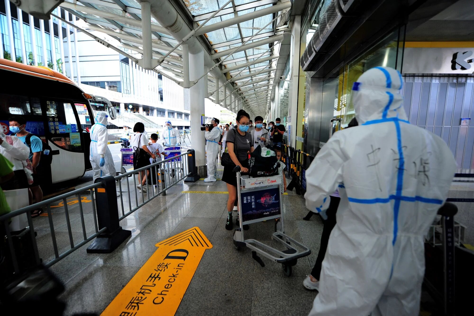 Tourists go through pre-departure formalities at the Sanya Phoenix airport as stranded holidaymakers prepare to leave the Covid-hit resort city of Sanya on Hainan Island on August 9, 2022 (AFP)
