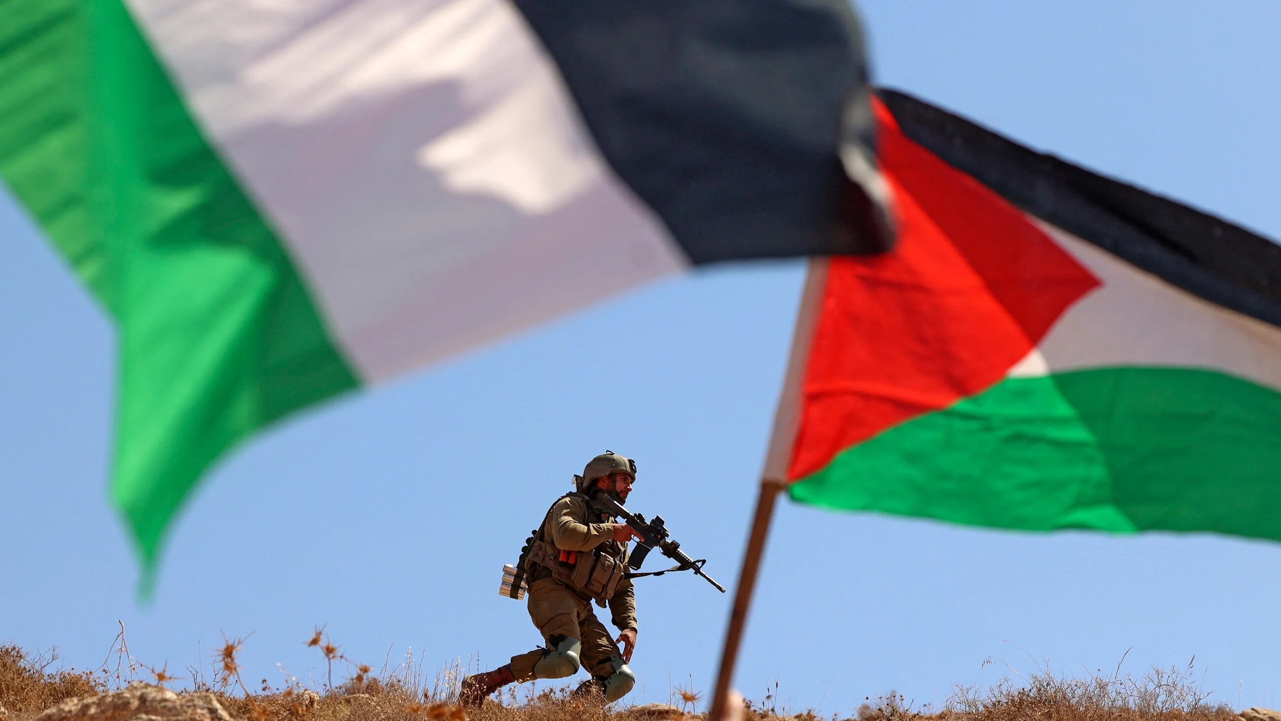 Israeli forces keep position during a crackdown on Palestinian anti-settlement protestors east of Nablus, in the occupied West Bank, on 9 September 2022 (AFP)