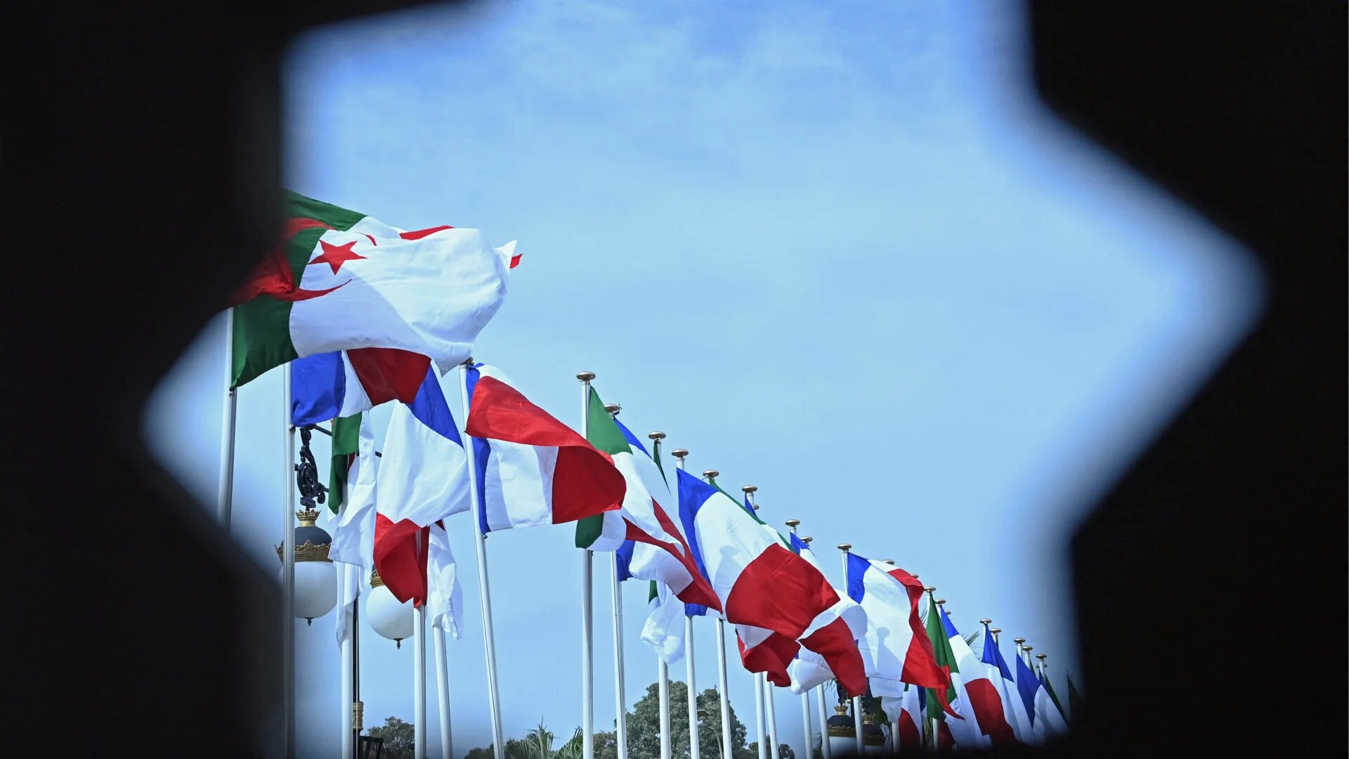 Algerian and French flags sway in Algiers on 9 October 2022, during a two-day visit by the French prime minister (Alain Jocard/AFP)