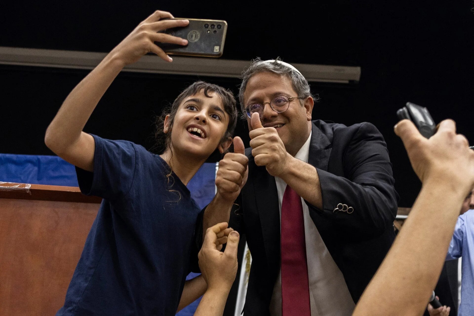 Itamar Ben-Gvir is greeted by his supporters during a campaign rally in the southern Israeli city of Ashkelon on 25 October (AFP)