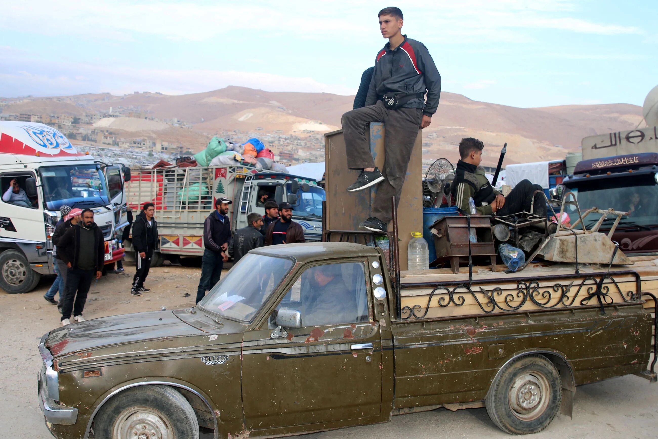 Syrians refugees prepare to leave Lebanon towards Syrian territory through the Wadi Hamid crossing in Arsal on October 26, 2022 (AFP)