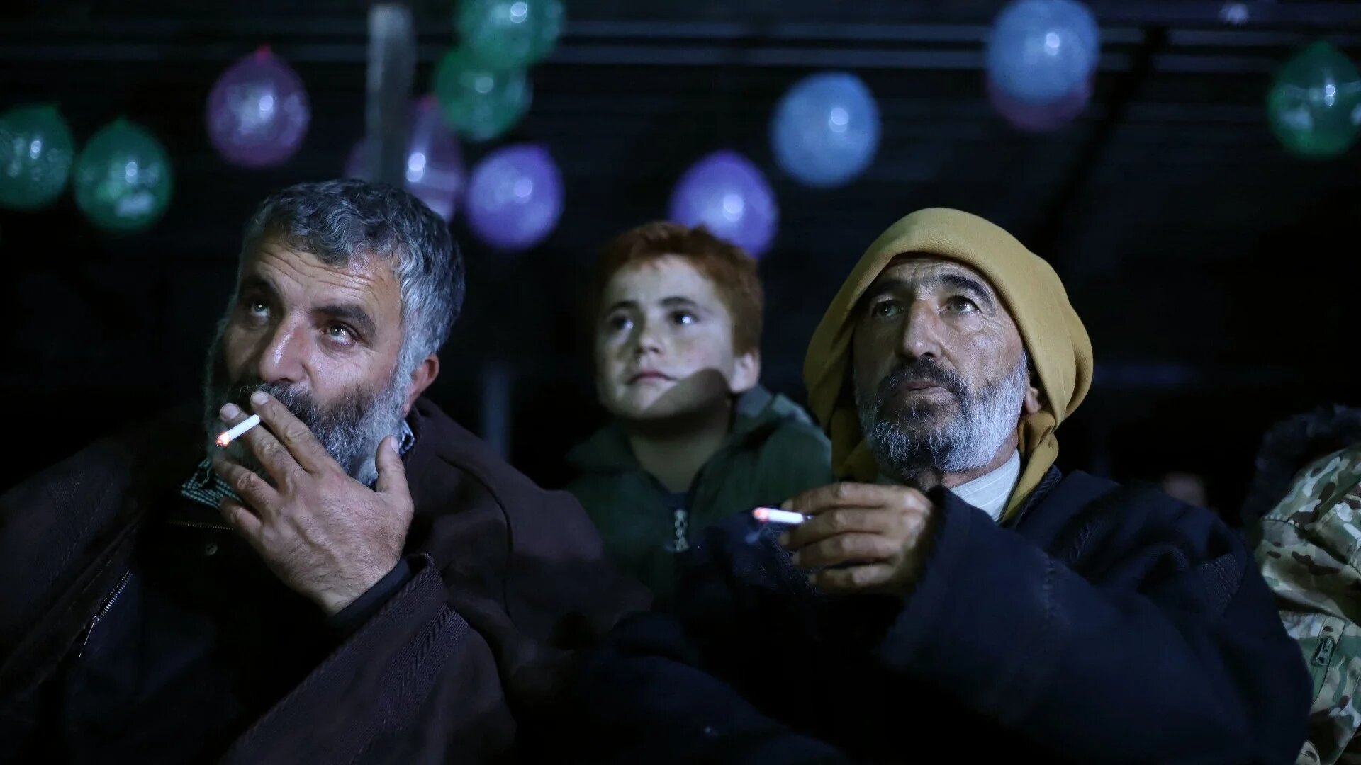 Syrians in a recently bombed displacement camp on the Turkish border watch the World Cup (AFP)