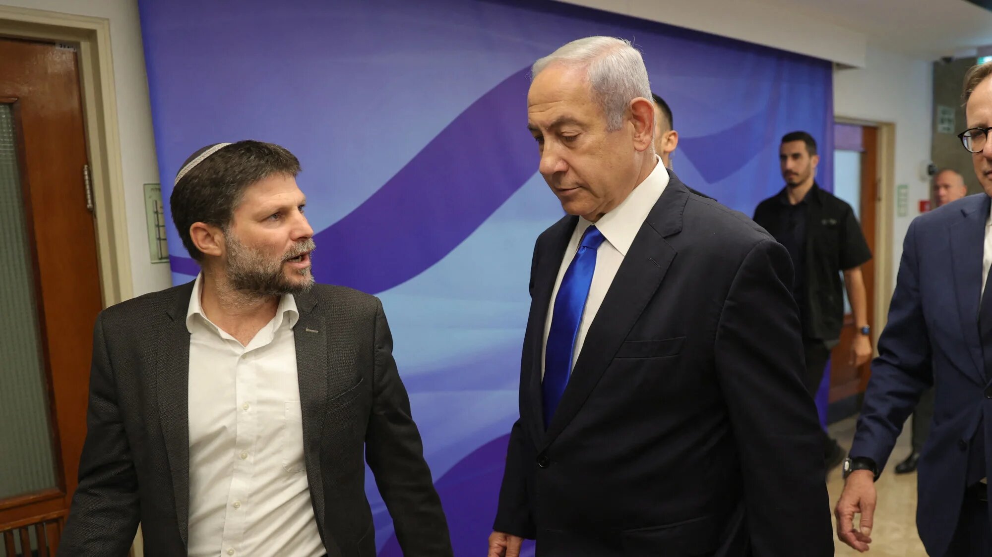 Israeli Prime Minister Benjamin Netanyahu speaks with with Finance Minister Bezalel Smotrich in Jerusalem, on 25 June 2023 (AFP)