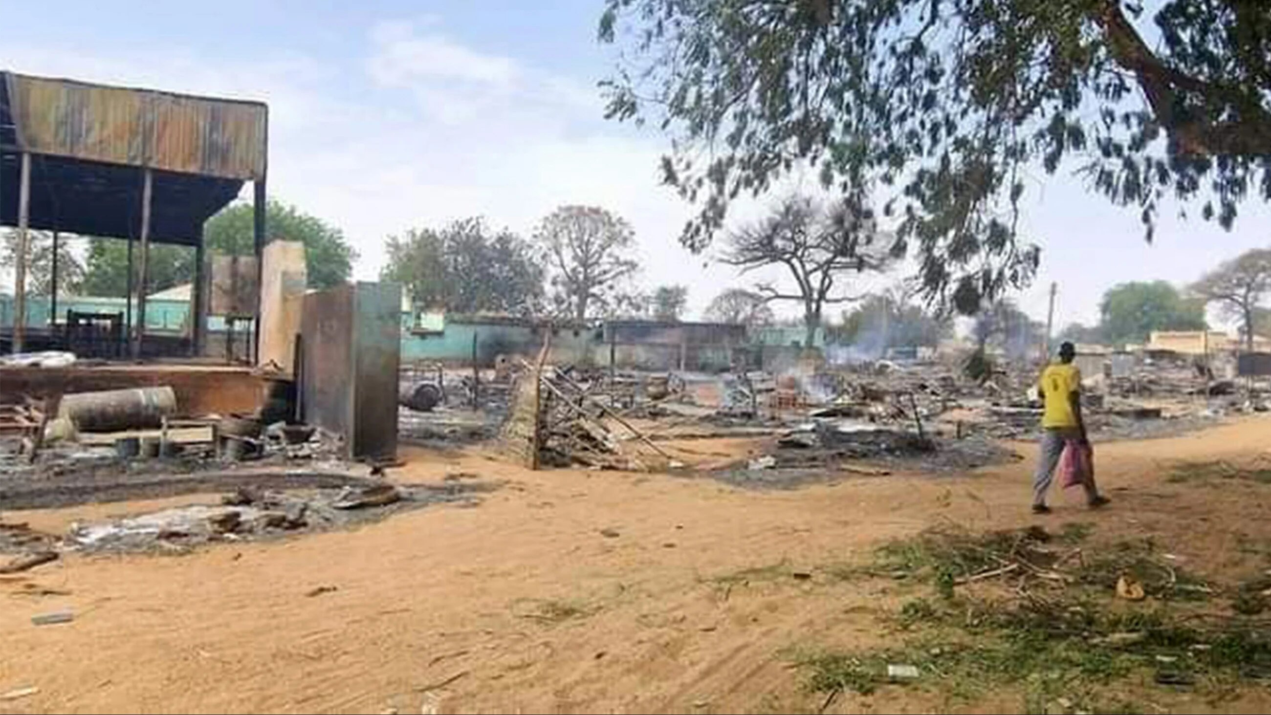 A man walks past a devastated market area in al-Fasher, the capital of Sudan's North Darfur state, on 1 September 2023 (AFP) 