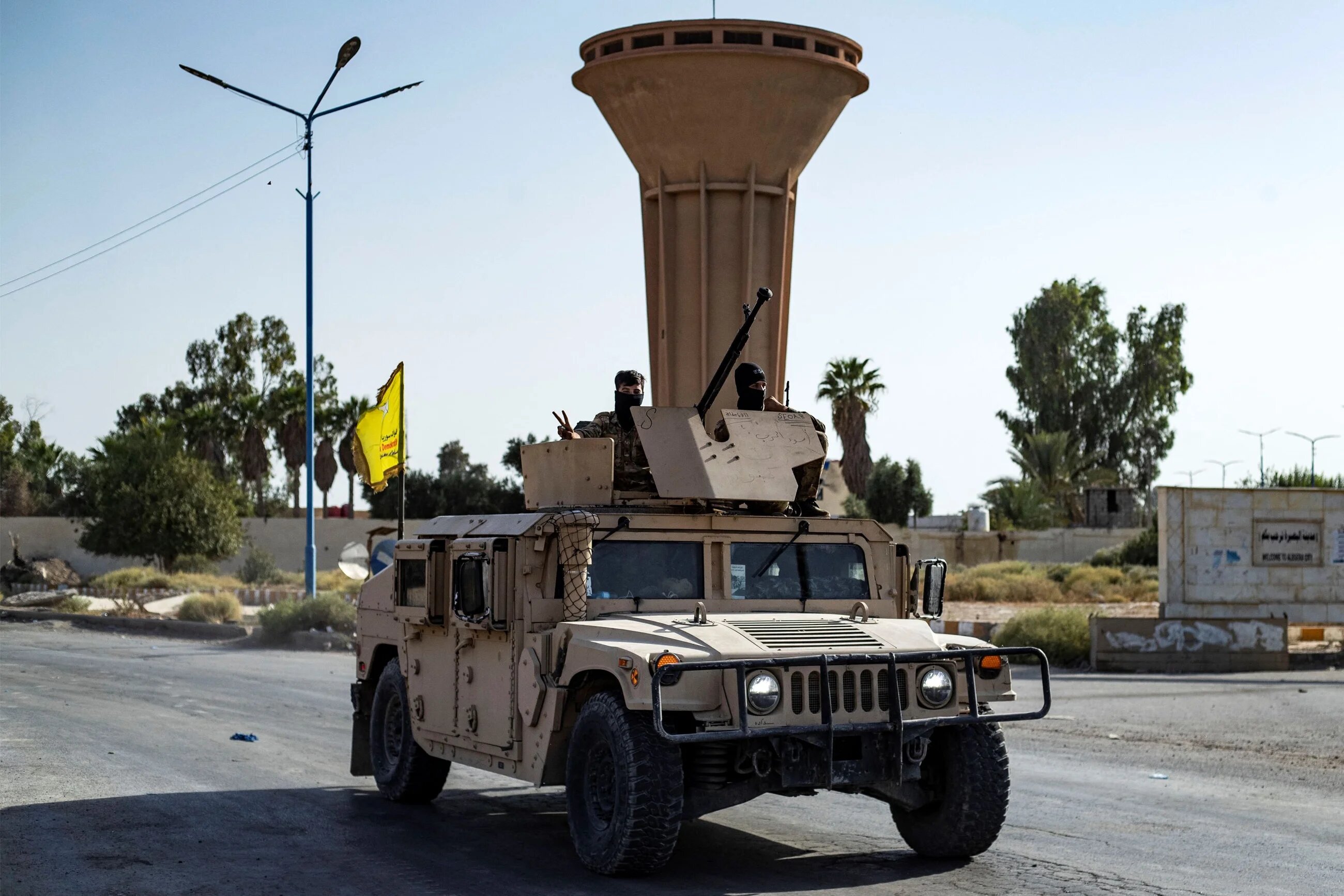 A Syrian Democratic Forces (SDF) vehicle on the road as fighters impose a curfew in the town of al-Busayrah in Deir Ezzor